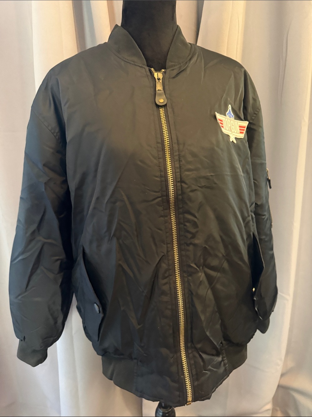 BRAND NEW. Black Bomber Jacket with Wing Patch. 100% Polyester. Fully Lined.